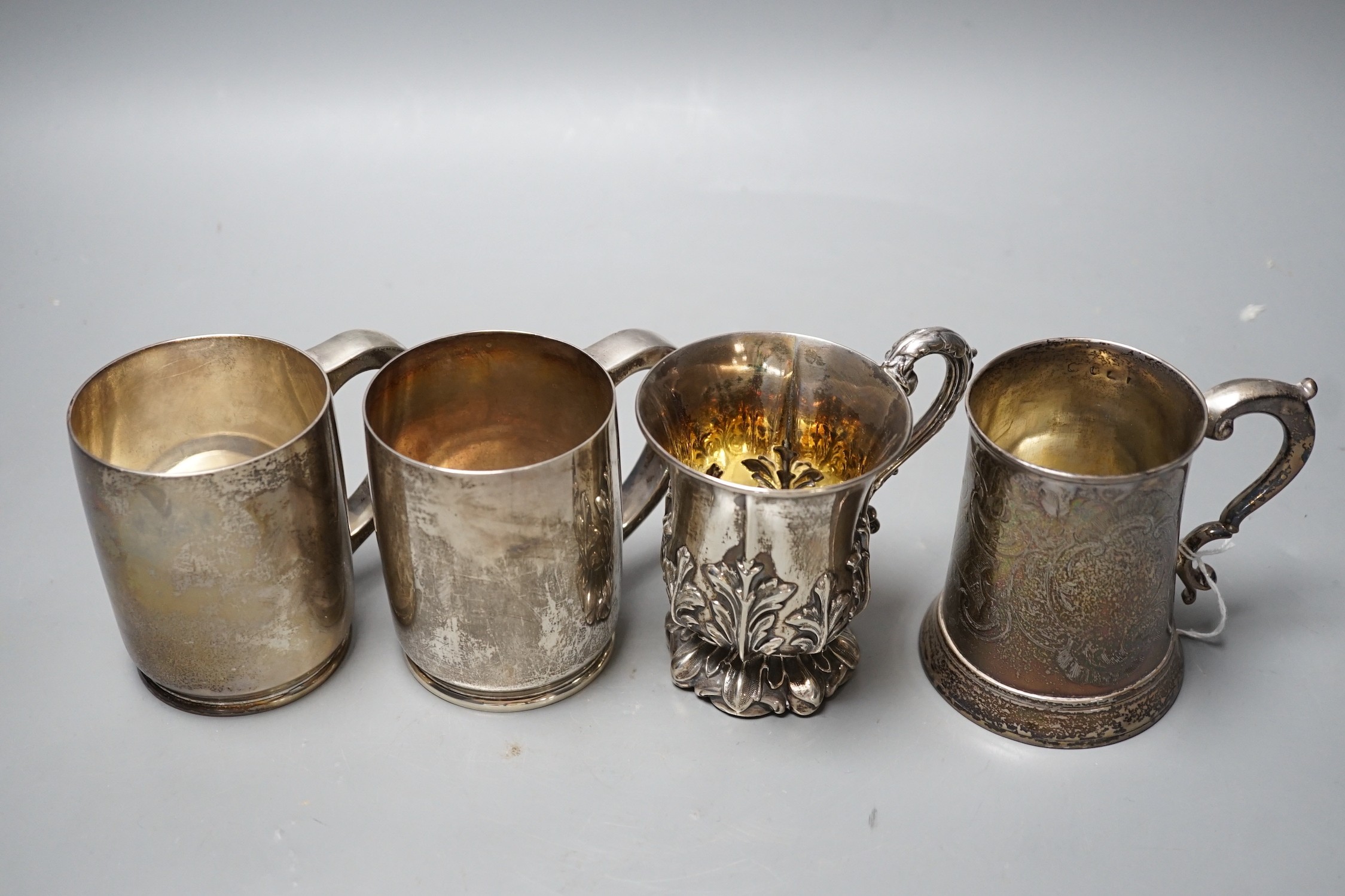 Four assorted silver mugs, including engraved George III, London, 1769, 94mm and a pair by Wakely & Wheeler, London, 1948/9, 26.1oz.